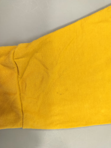 Pantalon jersey jaune, arrière tête de lion . Légère tache sur le dessous, moins cher chez Petit Kiwi